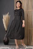 A woman in a black rayon maternity kameez