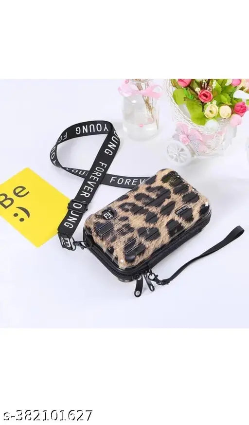 Fashionable women slingbag, black and gold leopard print fabric, zip closure
