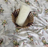 Lightweight pure georgette saree with netted sequence design and matching roll of paper towels on bed