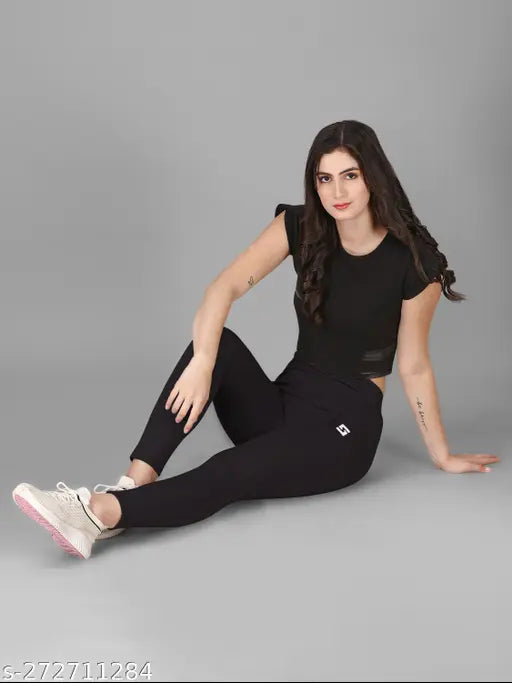 Black colorblocked tights for women's activewear, gymwear, yogawear. High-quality polyester, comfortable fit and flexible relaxation. Size: 28, 30, 32, 34, 36, 38 (waist 28-38 in, length 34-36 in). Made in India