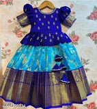 Soft silk kids pattu pavadai with floral stitch, short sleeves, and zari woven pattern. Available in various sizes from 12-13 years. Handcrafted Indian traditional lehenga set for girls' special occasions