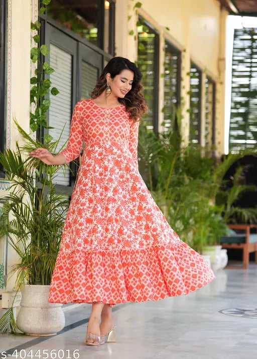Vibrant orange rayon kurtis with embroidered yoke, tassels, and multi-colored print. Sleeve length: three-quarter. India origin
