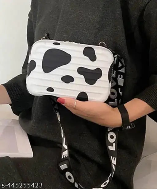 Black and white sling bag with detachable shoulder strap and convertible into cosmetic box bag, styled as a handbag or clutch, for women