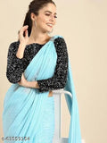 A woman wearing a light blue sari with dark embroidery details