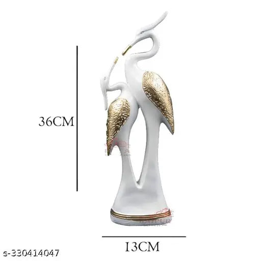 High-quality resin swan pair statue, big size for home decor. Represent love and peace in living room or bedroom. Weather resistant polyresin and fiberglass mix for long-lasting durability. Perfect gift for couples, newlyweds, lovers, or housewarming. 13cm x 36cm. Clean with dry or moist cloth. Made in India