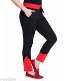 Black cotton slim fit sports track pants with a red side stripe, elastic waistband and pockets on the sides