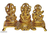Golden metal idol of Ganesha, Lakshmi, and Saraswati from India, ornamental figurines each approximately 10cm tall and 20cm wide