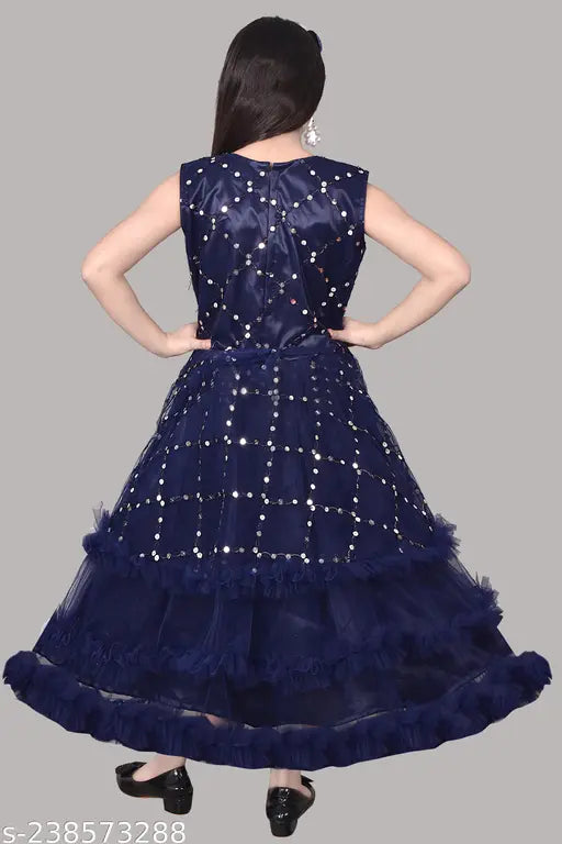 Blue satin dress with ruffle detailing and fringe accents