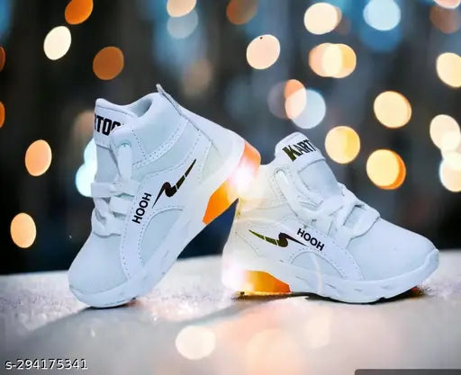 Kid's white tennis shoes with orange soles and glow-in-dark elements