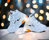 Kid's white tennis shoes with orange soles and glow-in-dark elements