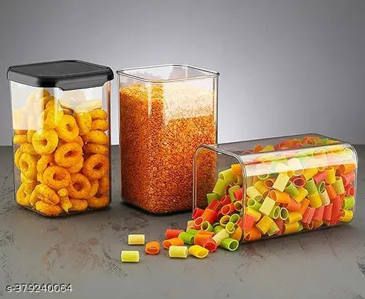 Clear plastic storage jars set with black lids, perfect for kitchen storage of snacks and dry goods.