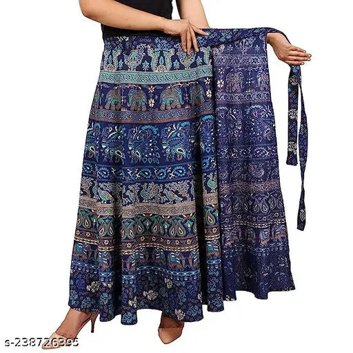 A woman holding a navy blue long skirt with intricate paisley print and cotton material