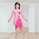 A pink dress with a doll print, sleeveless, ruffled hem, and possibly made of cotton or satin