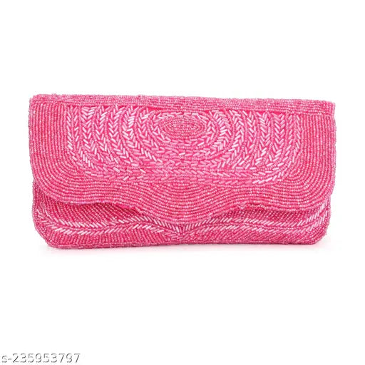 Hot pink designer fabric clutch with a rectangular shape and embellishments