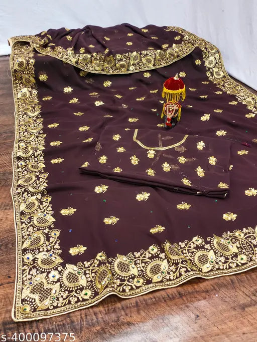 Gold paisley pattern on black fabric, likely for a woman's dress or outfit
