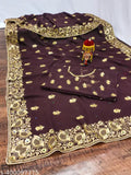 Gold paisley pattern on black fabric, likely for a woman's dress or outfit