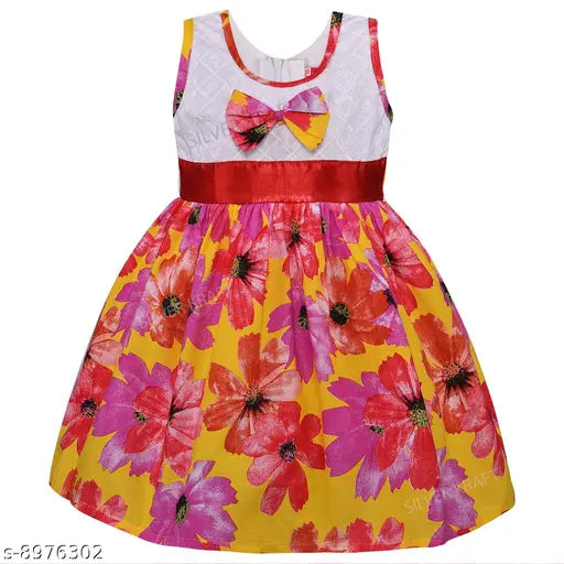 Yellow dress with floral pattern, ruffled hem, pink flower bow accent