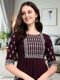 A woman wearing a black outfit with embellished embroidery