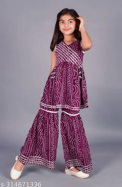 Rayon printed kurta and sharara set for girls in A-line style, featuring V-neck, sleeveless design, Bandhani print, Gotta work, and lace detailing. Perfect for parties, weddings, or festivals