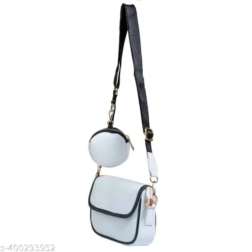 White sling bag with gold accents and adjustable strap