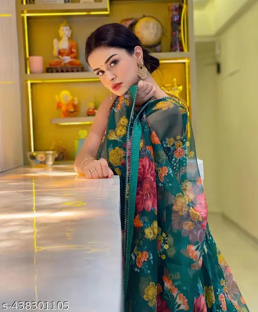 Green mirror work digital printed lehengha choli with floral dupatta, embellished top and floral net bottom on mannequin