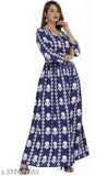 A woman wearing a long blue rayon dress with a floral print, three-quarter sleeves, and an ankle length skirt