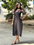A stylish black kameez worn by a woman with black hair and black sandals
