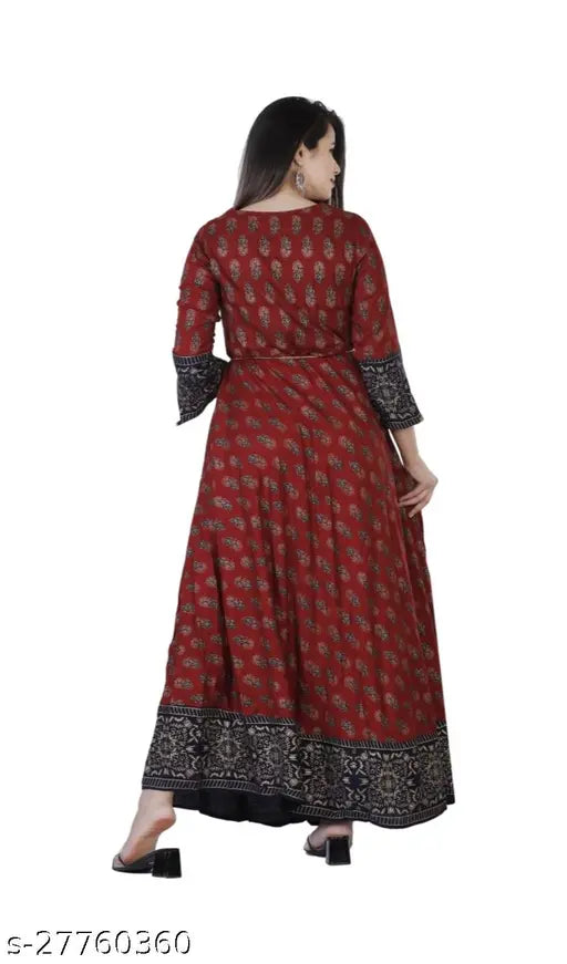 Long, red dress with maroon floral patterns, fitted at waist