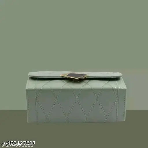 Grey quilted sling bag with a flap closure