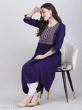 A woman wearing a long, dark blue embroidered kurta