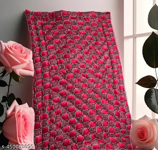Red, cotton quilt with intricate pattern and rectangular shape