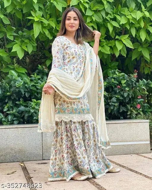 A woman wearing a short kurta and dupatta set with a rayon print