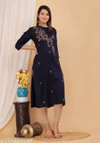 Embroidered navy blue kameez with long skirt and embroidery on chest, arms, and front of garment