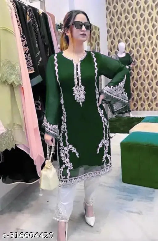 Green Georgette women's salwar suit set with heavy embroidery work, full-sleeved top and white pants on display