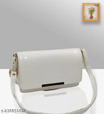 White crossbody purse with flap closure, slender design, metallic hardware