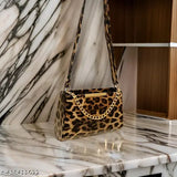 Black leopard print purse, featuring multiple pockets and a chain strap, with metal hardware