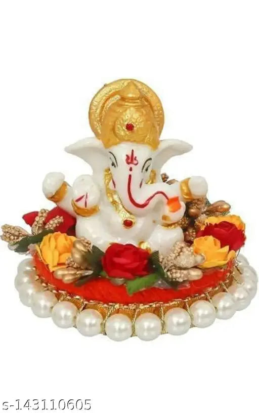 Multicolor polyresin Ganesha idol sitting on gungroo bangles, adorned by flowers. Vibrant decorative showpiece, 9 cm tall and 10 cm wide