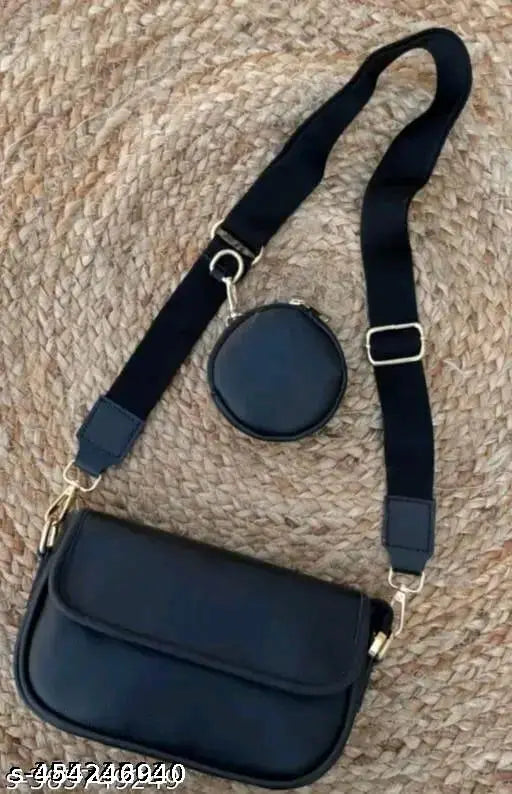 Black leather crossbody bag with adjustable shoulder strap and circular metal clasp