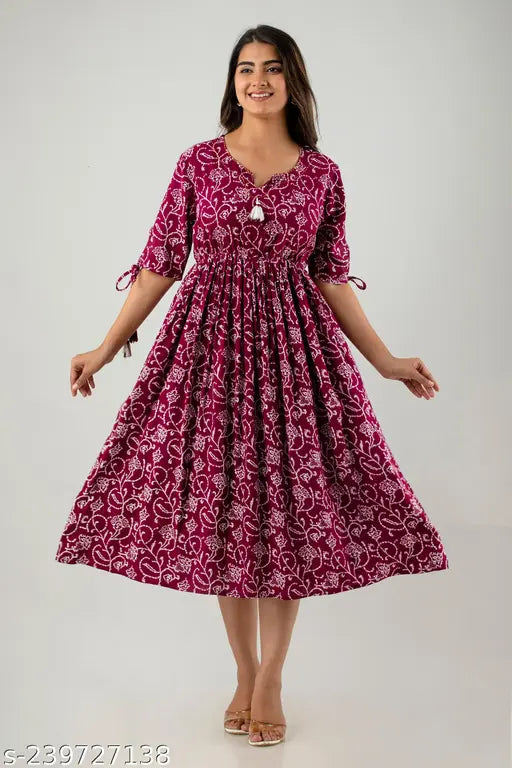 Printed cotton rayon woman's long anarkali kurta with 3/4 sleeves, tassels on sleeves, hand-worked round neck. Not affected by washing