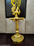 Golden peacock designer metal diya stand, intricately designed Indian decor item with a height of 21 cm and breadth of 10 cm