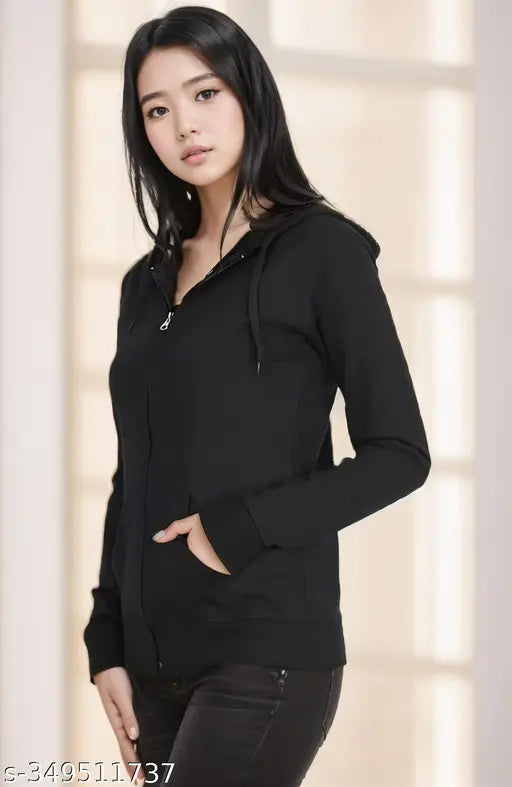 Black fleece long-sleeve jacket for women, solid design on a clothing rack