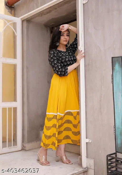 Yellow rayon calf length printed kurti with round neck and 3/4 sleeves for women, paired with matching dupatta set
