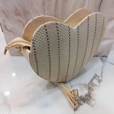 Heart-shaped sling bag in soft jute fabric, with shoulder belt and knot design, handheld handle