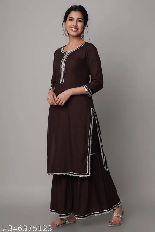 Coffee-colored rayon solid printed Kurta-Palazoo set with gharara, three-quarter sleeves. Rayon fabric for women's traditional Indian attire. Single size, XS (38 in), S (40 in), M (42 in), L (44 in), XL (46 in), XXL (48 in). Handcrafted in India