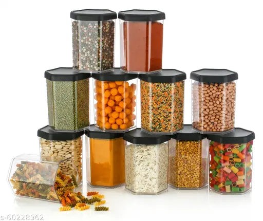 These are a dozen hexagonal spice jars, each containing various types of spices and herbs. They have black caps and can be used for storage in the kitchen. Each jar has a label on it that reads 'Spice Masala'. The jars are transparent, allowing the contents to be seen. There is no visible text other than the labels on the jars