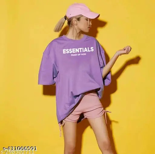 A person in a purple hoodie with the word "essentials" on it, posing with one hand on hip against a yellow background