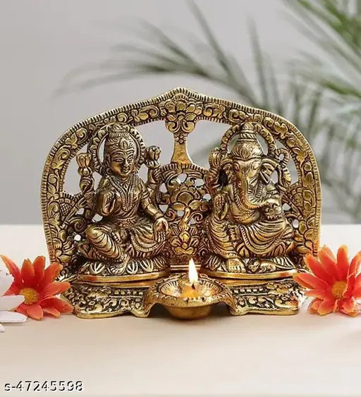 Decorative Hindu God idols of Laxmi and Ganesh with a lit diya, set against a floral background