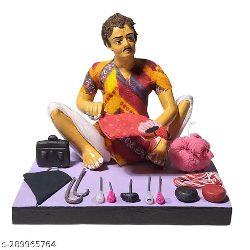Handcrafted terracotta miniature of a man sitting and working on an umbrella, surrounded by vibrant rainbow feathers, traditional crafts, and rural themes