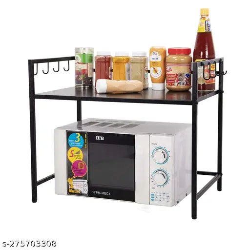 Black metal storage stand for kitchen appliances, holding a microwave oven and various bottles and jars