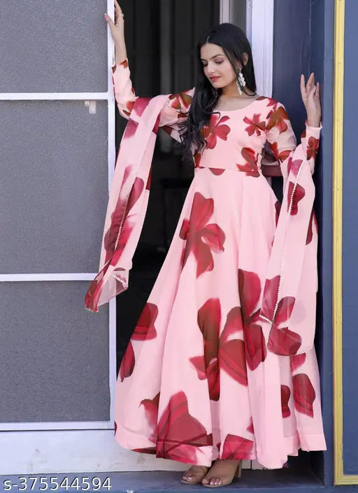 The image showcases a woman wearing a pink floral sari with a matching dupatta. It appears to be a festive or celebratory attire, possibly for an occasion like a wedding or a cultural event. The attire is made of teddy silk fabric and has a regular fit style